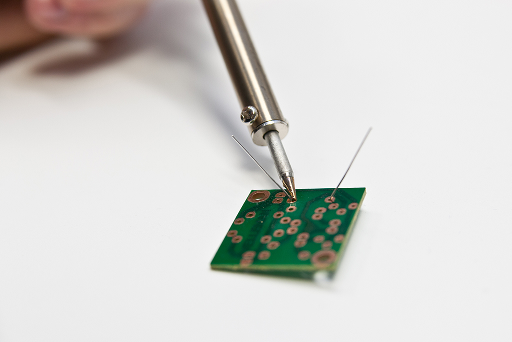 Heat up the path and the lead by using the tip of your soldering iron
